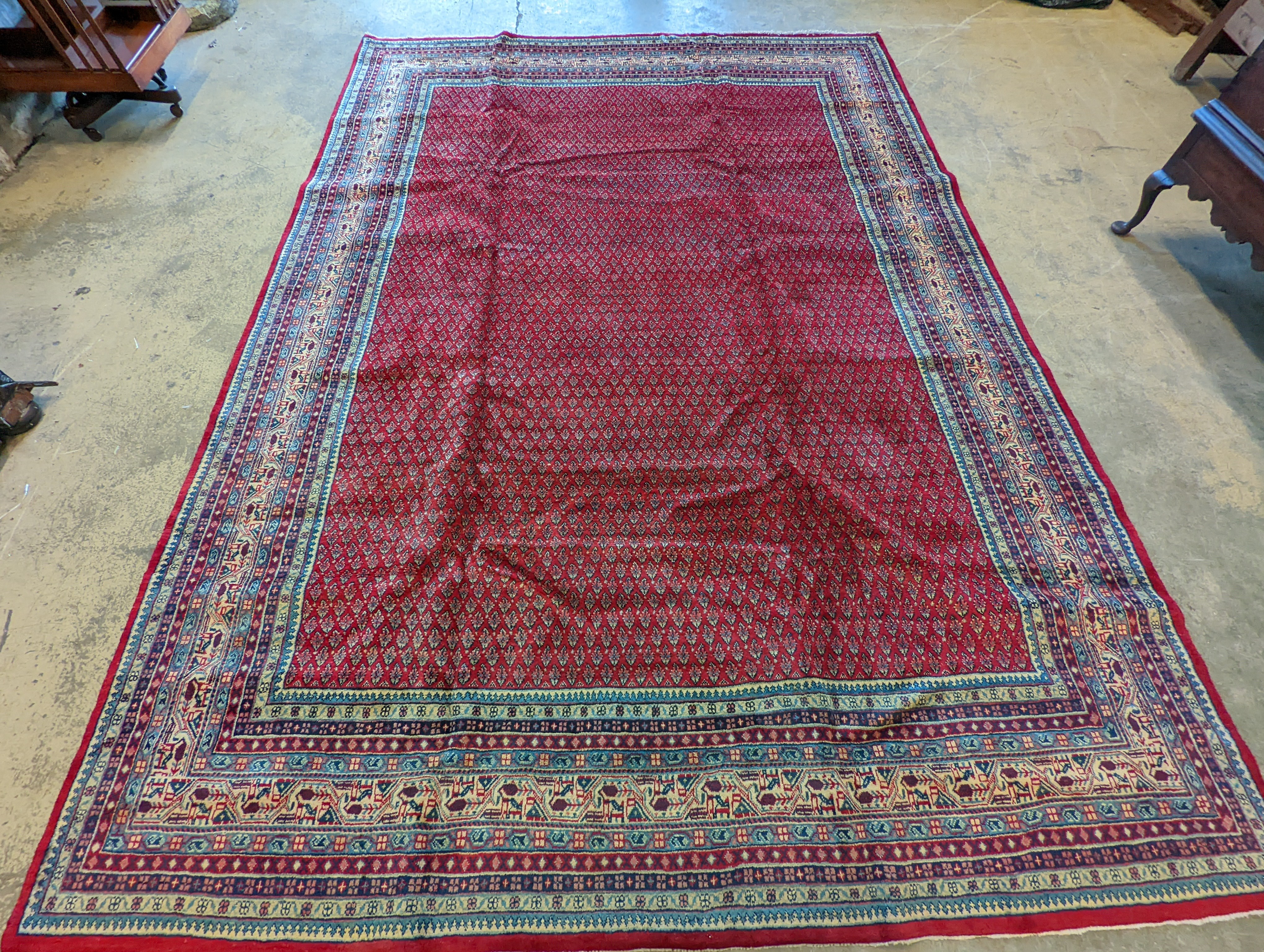 An Araak crimson ground carpet, 350 x 250cm
